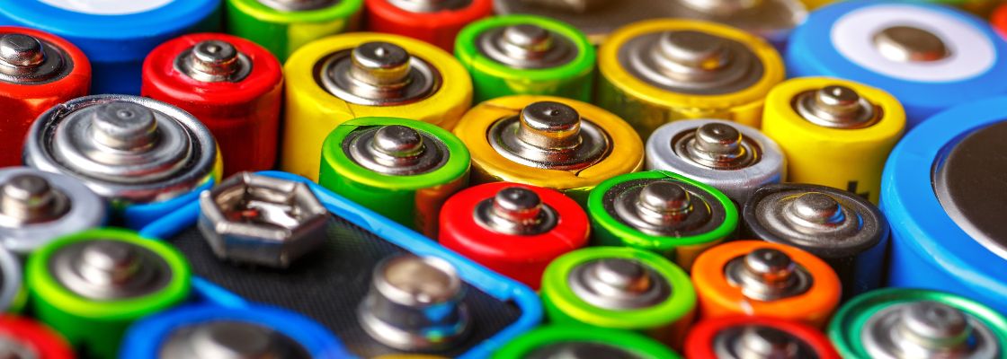 Abstrakter Hintergrund von bunten Batterien.Alte gebrauchte Batterien für das Recycling.Gebrauchte Batterien verschiedener Hersteller, Abfälle, Sammlung und Recycling, Alkaline-Batteriegröße.